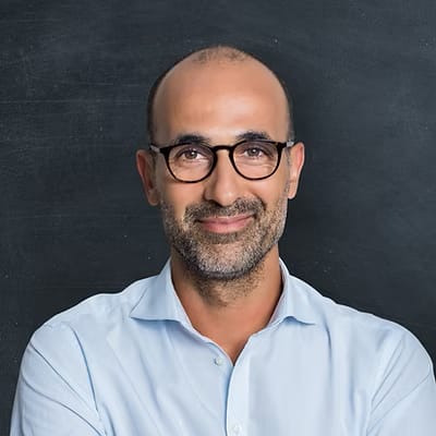 Headshot of testimonial man. Man is smiling and looking at the camera wearing a shirt.